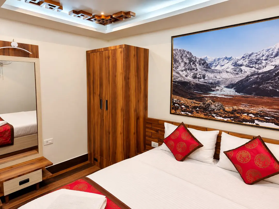 Deluxe Super Room 3 showing the wardrobe, dressing mirror and framed Himalayan photograph